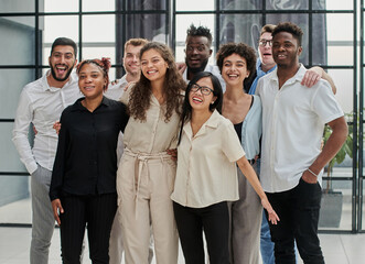 Fototapeta premium Team at work. Group of young business people in smart casual wear working together in creative office