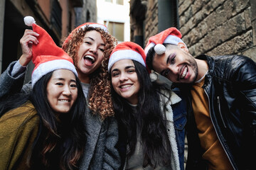 Happy diverse people having fun outdoors during Christmas day - Holiday concept - Focus on gay transgender man face