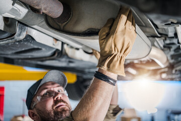 Professional Mechanic Performing Car Catalytic Converter Check - 548594548