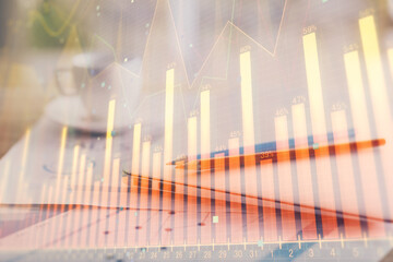 Forex graph hologram on table with computer background. Double exposure. Concept of financial markets.