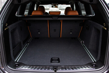 Huge, clean and empty car trunk in interior of compact suv. Rear view of a SUV car with open trunk - obrazy, fototapety, plakaty