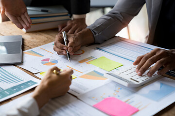 Asian business colleagues meeting to analyze financial reporting situation Investment and accounting concept sitting table and pointing at document. Profit chart. Graph showing growth.