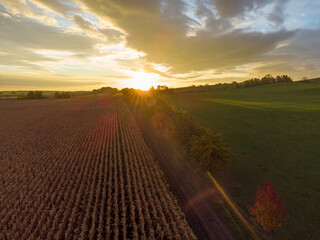 Aerial view of sunset behind a field in the countryside