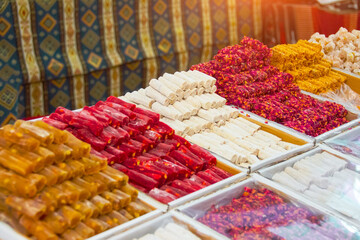 Traditional delights sweet rolls, oriental sweets lukum, lokum, nougat arranged in boxes on the counter of the store.