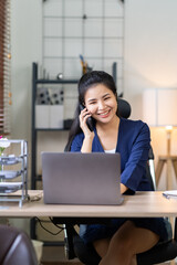 Obraz premium Portrait of an Asian businesswoman using a mobile phone while checking email or social media on the Internet. concepts of finance, accounting, and marketing.