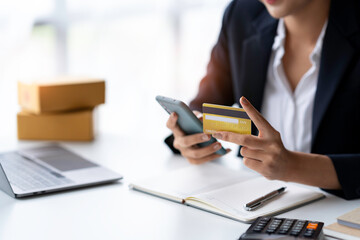 Fototapeta premium Asian businesswoman hands holding smartphone shopping online with a credit card. Online Payment. Online shopping