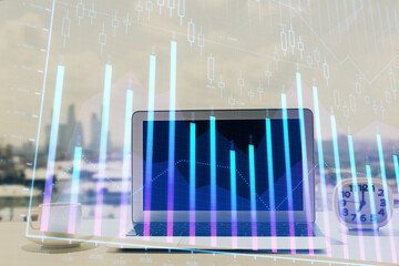 Forex graph hologram on table with computer background. Multi exposure. Concept of financial markets.