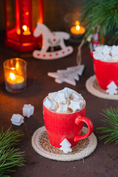 Festive composition, cocoa with star-shaped marshmallows in a red cup on a brown concrete background in Christmas style. Merry Christmas concept. Winter holidays.