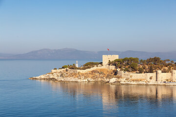 Fototapeta na wymiar Historic Landmark, Kusadasi Castle, in a Touristic Town by the Aegean Sea. Kusadasi, Turkey. Sunny Morning Sunrise.