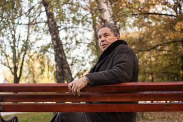 Fototapeta premium Lonely senior man sitting on bench