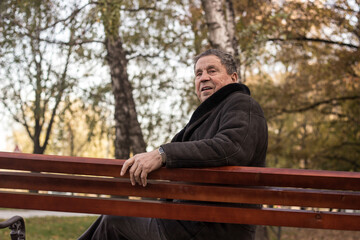 Fototapeta premium Lonely senior man sitting on bench