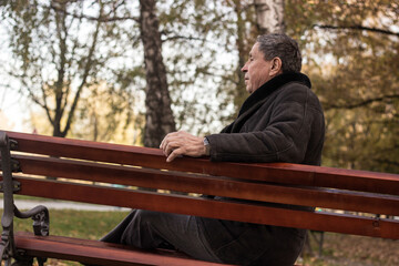 Fototapeta premium Lonely senior man sitting on bench