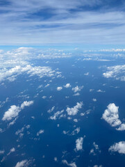 Stunning view of the expanse of land and sky, shot from thousand feet above the ground among white clouds. Smartphone photography