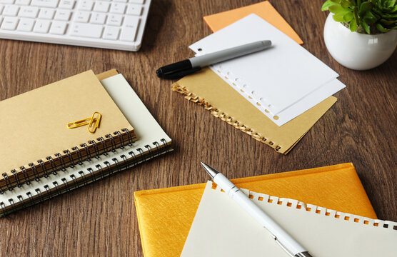 wooden office table with yellow notepad and supplies. Table. Top view with place for text. plant in the pot