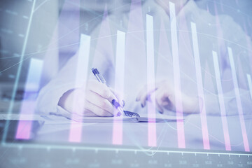 Financial chart drawn over hands taking notes background. Concept of research. Multi exposure