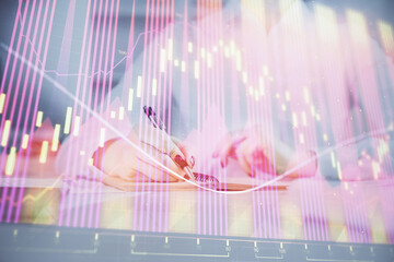 Financial chart drawn over hands taking notes background. Concept of research. Multi exposure