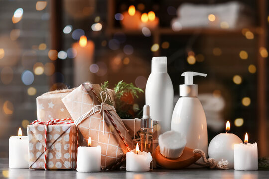 Christmas gift boxes, candles and products for spa treatment on table