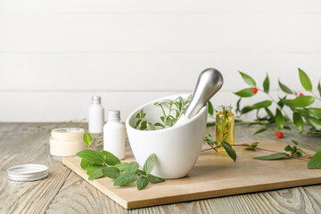 White mortar with herbs on light wooden table