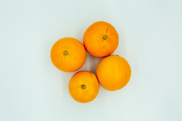 fresh oranges on a white background. Close-up shot of oranges from above. Vitamin C source, diet and vegan diet. Banner