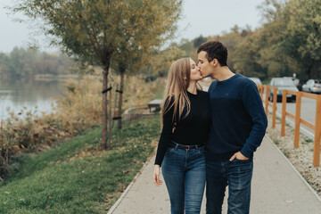 Young couple walking in a park, kissing