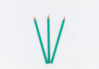 green pencils on a white background. The most important tool for a student: Pencils