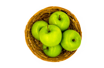 a basket of green apples on a white background. Healthy foods and diet foods. Fruits and healthy eating. Green apples, source of health and flavor