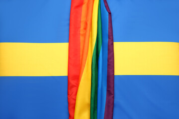 Flags of LGBT and Sweden as background, closeup