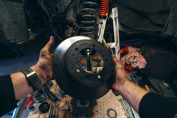 Car service from the first person mechanic. Male hands. Repair of the front wheel hub, replacement...