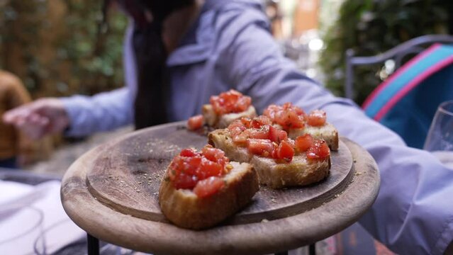 Bruschetta food on wooden plate at restaurant. Traditional Italian meal appetizer