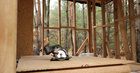 Circular saw in a wooden house under construction
