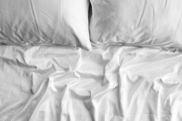 White sheets and pillows on bed, closeup