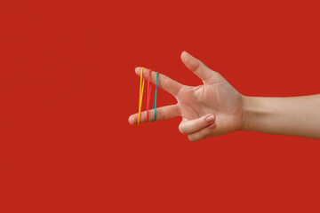 Woman with rubber bands on red background