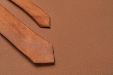 Stylish necktie on brown background