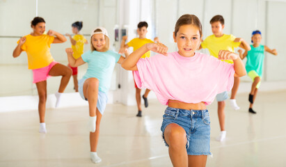 Young girls and boys performing hip-hop dance in studio.