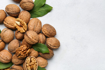 Heap of fresh walnuts on light background, closeup