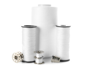 Different thread spools and thimble isolated on white background