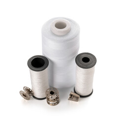Different thread spools and thimble isolated on white background