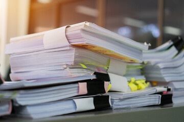 Document of paper or paperwork file unfinished pile report. Stack Papers documents folder with black clipper preparing signature or approval information from administrator on desk in busy office