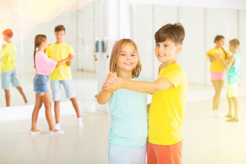 Boys and girls dancing waltz during their group class.