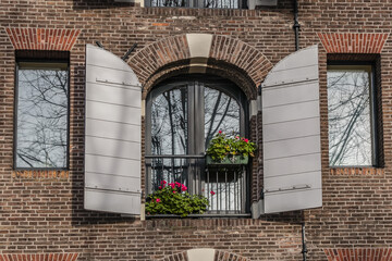Old building (XVII- XVIII centuries) with gable rooftop and hook Amsterdam’s Kattenburg. Kattenburg is Island in Amsterdam that were built in second half of XVII century. Amsterdam, the Netherlands.