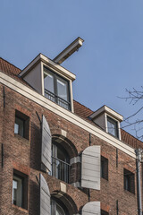 Old building (XVII- XVIII centuries) with gable rooftop and hook Amsterdam’s Kattenburg. Kattenburg is Island in Amsterdam that were built in second half of XVII century. Amsterdam, the Netherlands.