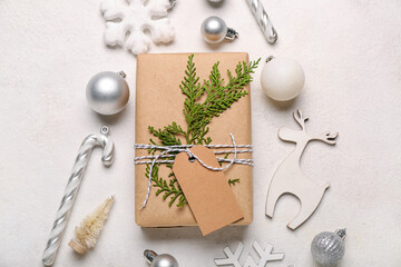 Composition with Christmas gift and beautiful decorations on light background, closeup