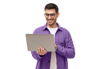 Young happy man standing with opened laptop, browsing online or typing message