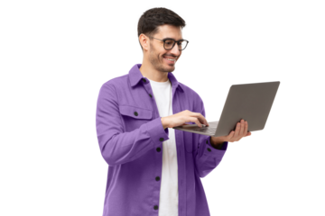 Young man wearing casual purple shirt, standing with opened laptop in hands, surfing online