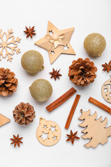 Composition with Christmas decorations, spices and cones on light background