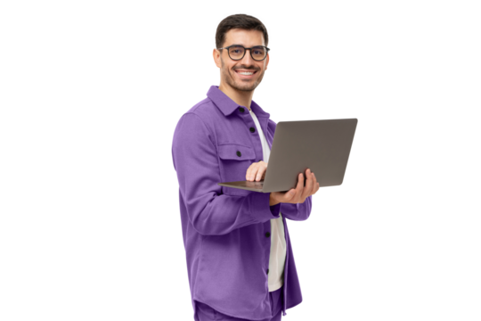 Portrait of young modern businessman standing holding laptop and looking at camera with happy smile