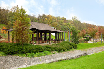 View of autumn park with gazebo and trees