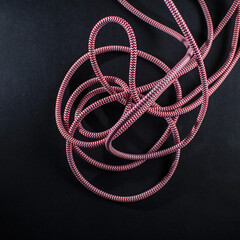 Red and White Braided Cable on Black Background