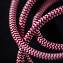 Red and White Braided Cable on Black Background