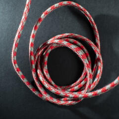 Red and Grey Braided Cable on Black Background